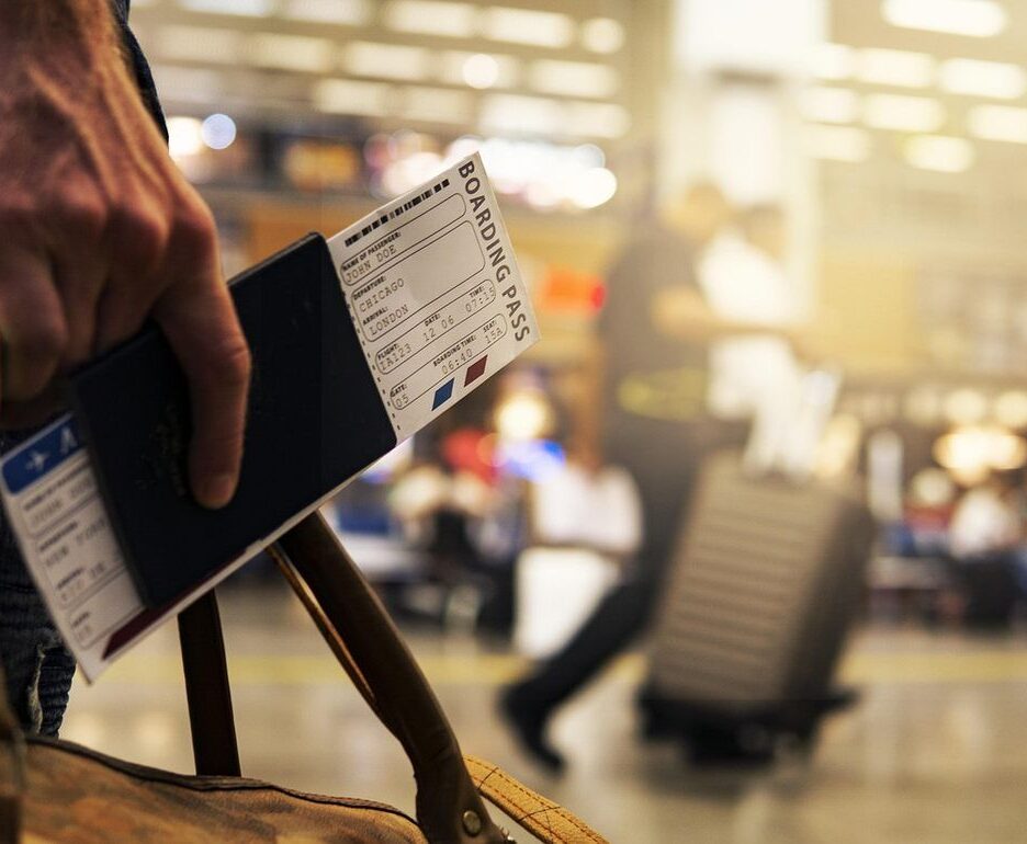 Main tenant passeport et carte d'embarquement à l'aéroport. Voyageur avec valises. Activité de voyage